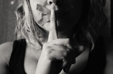 woman-placing-her-finger-between-her-lips-568025/